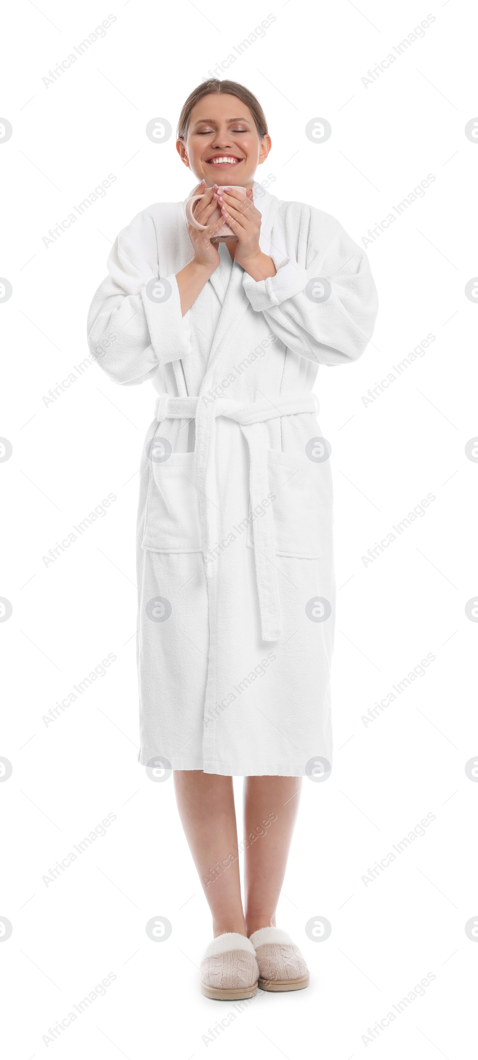 Photo of Young woman in bathrobe with cup of beverage on white background