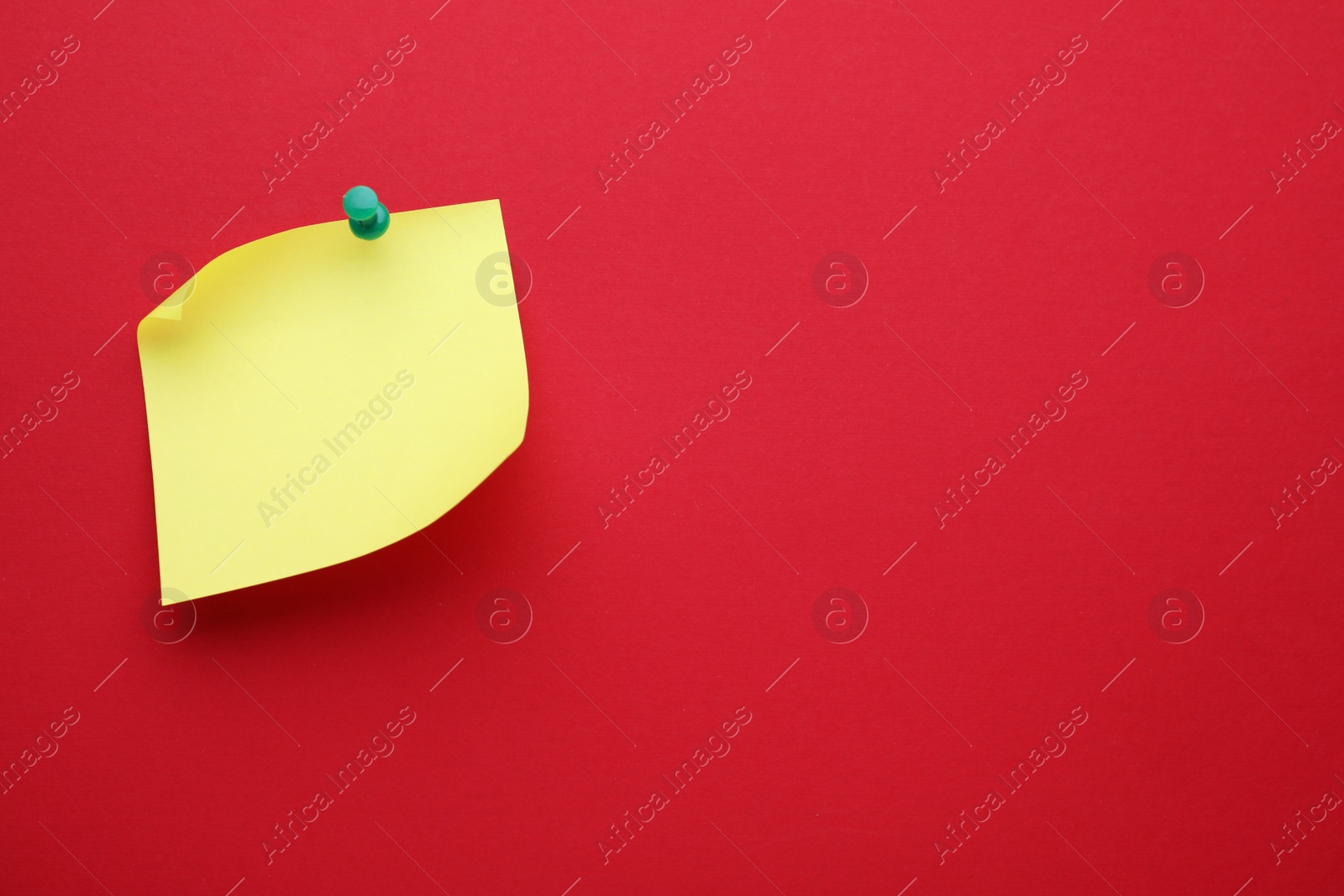 Photo of Paper note on red background, top view. Space for text