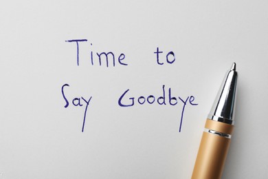 Pen and phrase Time to say Goodbye written on white paper, top view