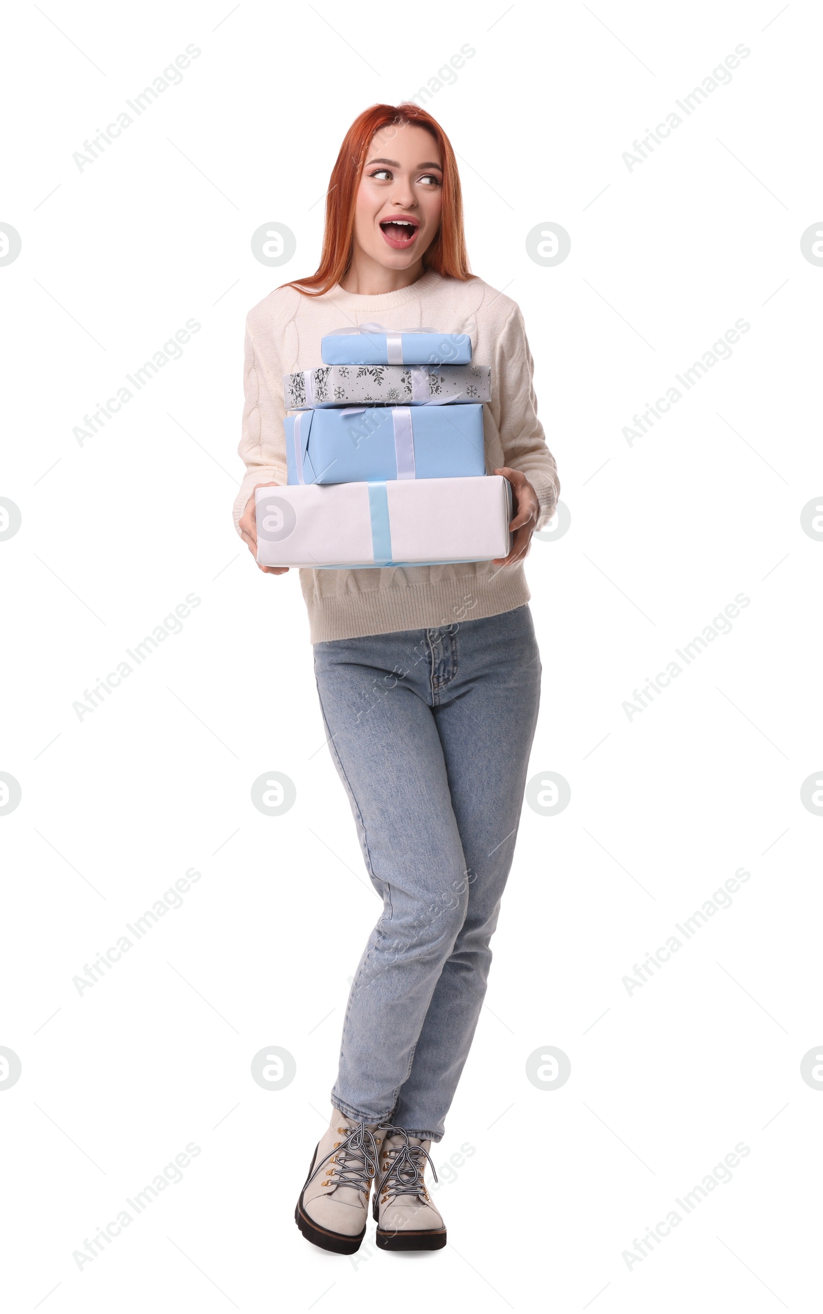 Photo of Emotional young woman in sweater with Christmas gifts on white background