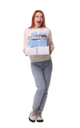 Photo of Emotional young woman in sweater with Christmas gifts on white background