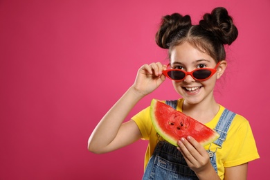 Cute little girl with watermelon on pink background. Space for text