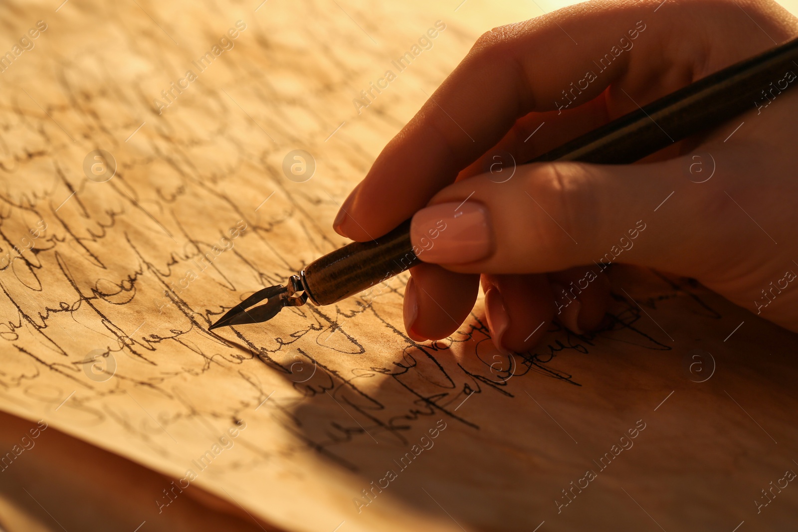 Photo of Woman writing letter with fountain pen, closeup