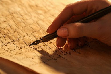 Woman writing letter with fountain pen, closeup