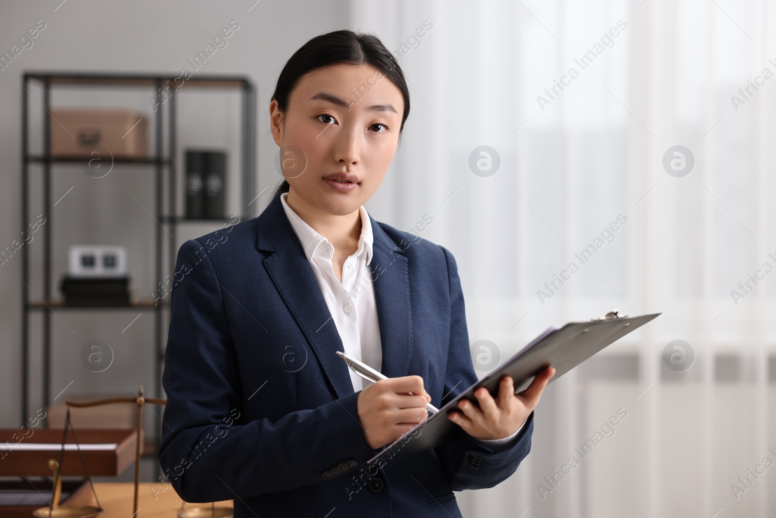 Photo of Portrait of notary with clipboard in office