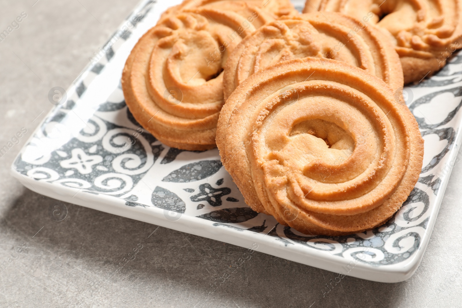 Photo of Plate with Danish butter cookies on table, closeup