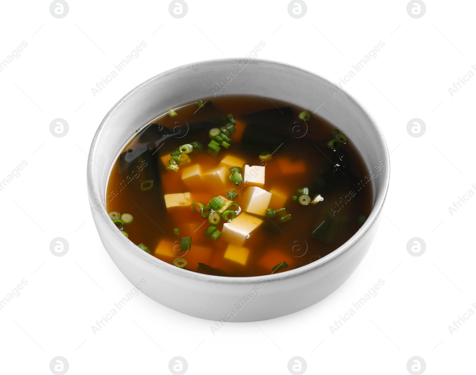 Photo of Bowl of delicious miso soup with tofu isolated on white