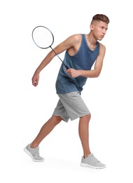 Young man playing badminton with racket on white background