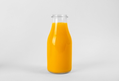 Photo of Bottle with delicious fresh juice on white background