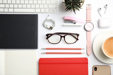 Photo of Flat lay composition with eyeglasses and office stationery on white background