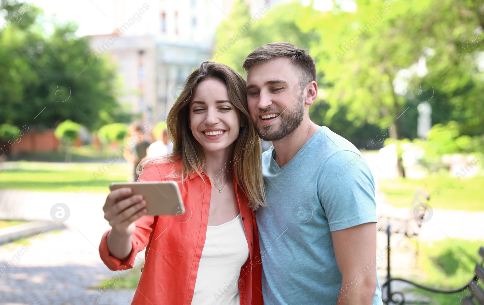 Photo of Happy young couple taking selfie in park