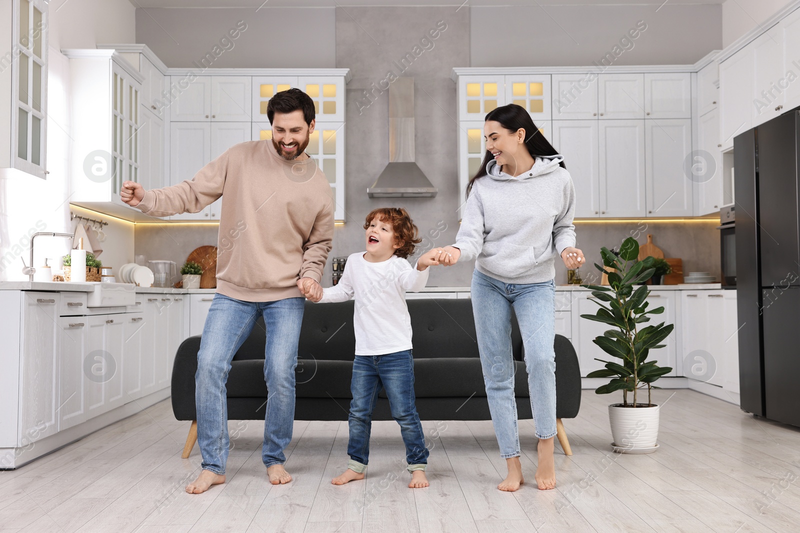 Photo of Happy family dancing and having fun at home