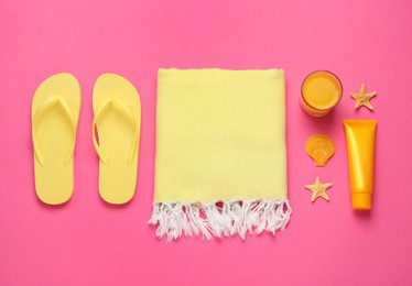 Flat lay composition with different beach objects on pink background