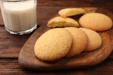 Delicious Danish butter cookies and milk on wooden table, closeup