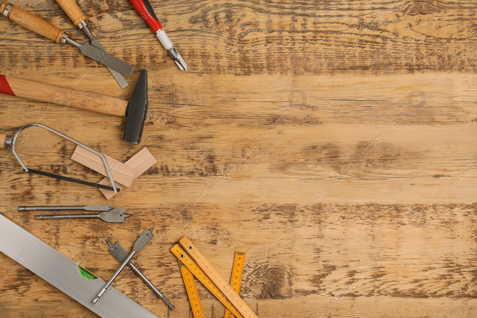 Photo of Flat lay composition with carpenter's tools on wooden background. Space for text