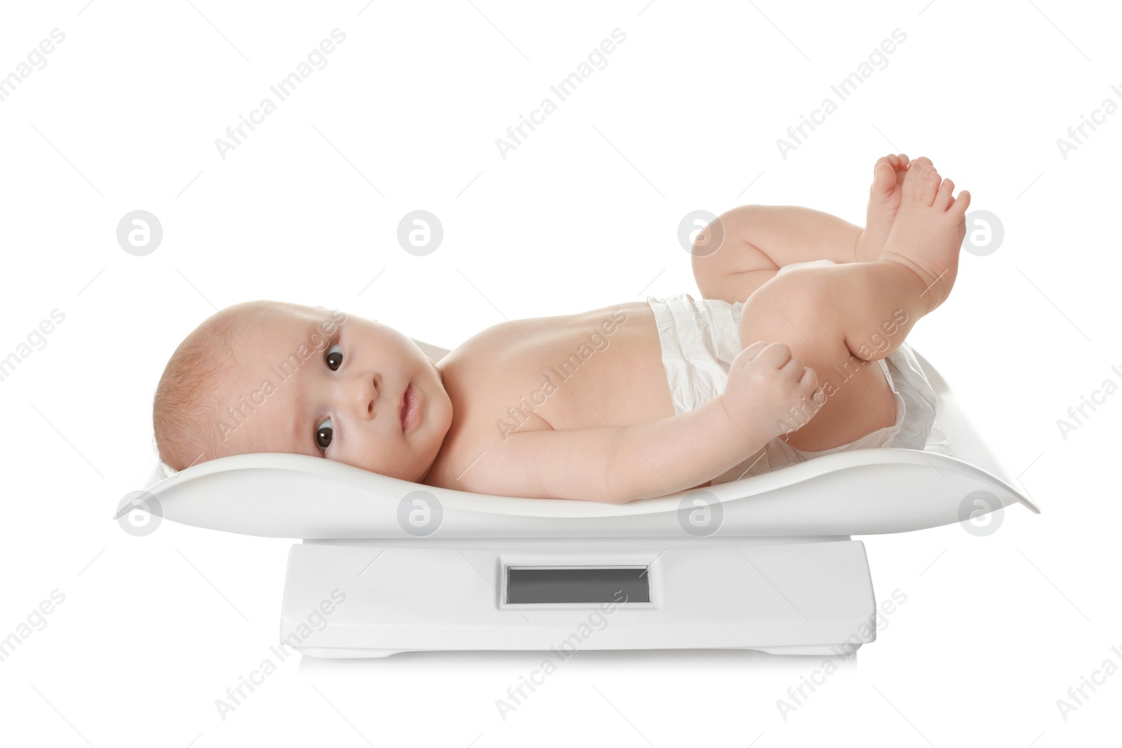 Photo of Cute little baby lying on scales against white background