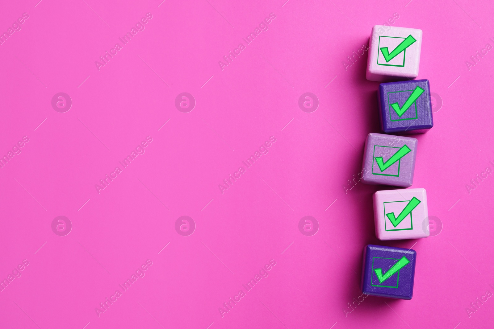 Image of Cubes with check marks on pink background, flat lay. Space for text