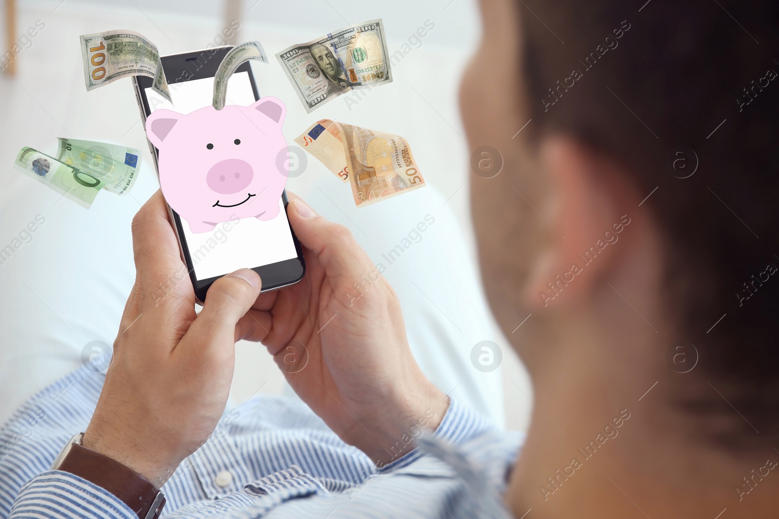 Image of Man using online bank application on his smartphone indoors