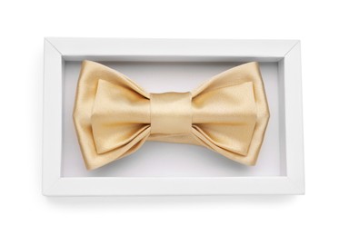 Stylish beige bow tie in box on white background, top view