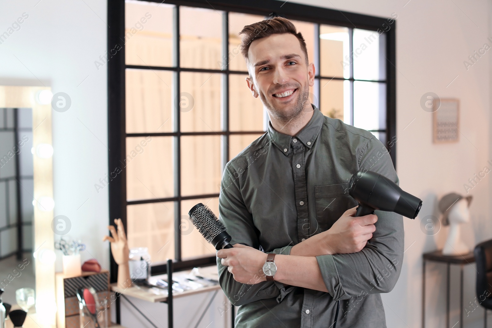 Photo of Professional hairdresser in beauty salon