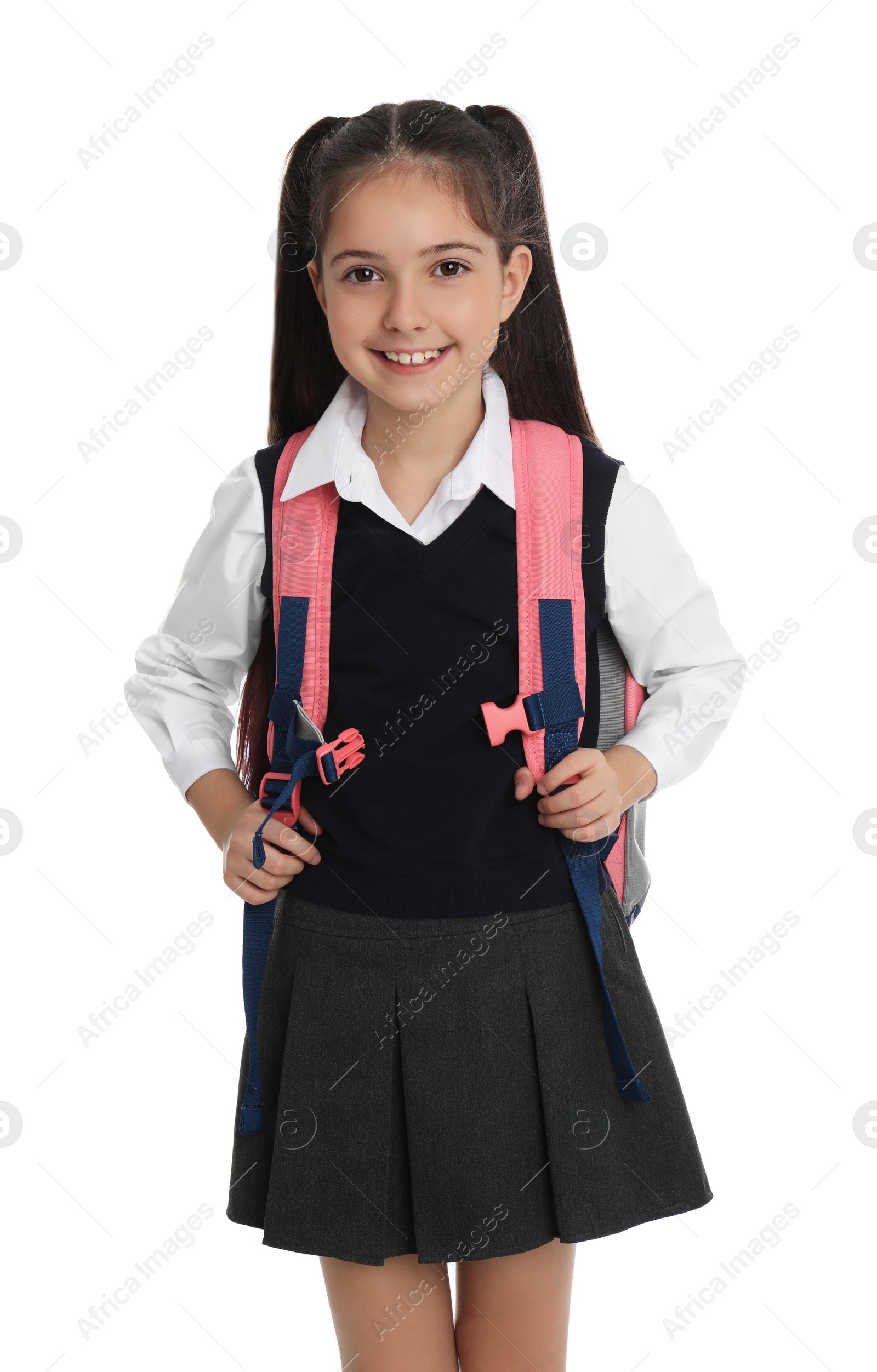 Photo of Little girl in school uniform with backpack on white background