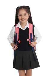 Photo of Little girl in school uniform with backpack on white background
