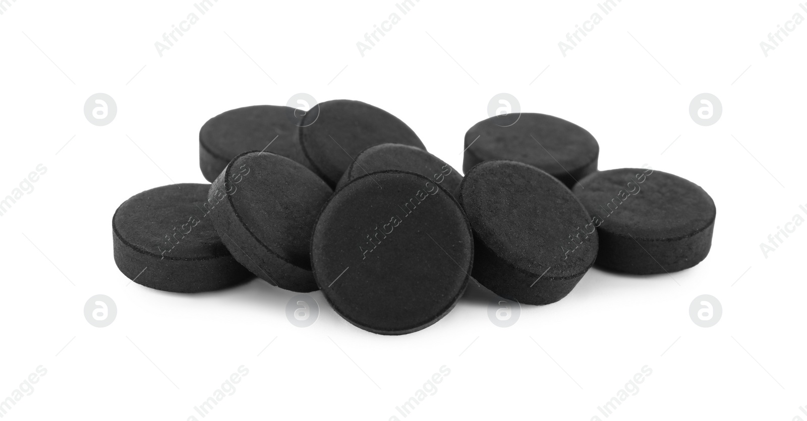 Photo of Activated charcoal pills on white background. Potent sorbent