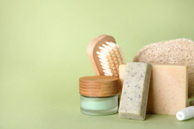 Photo of Eco friendly personal care products on light green background. Space for text
