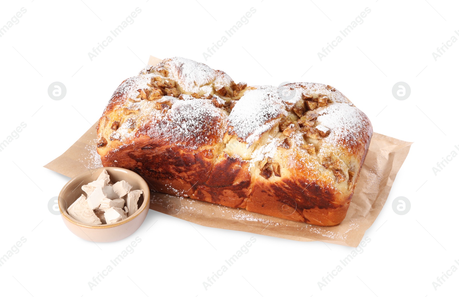 Photo of Delicious cake and pieces of compressed yeast on white background