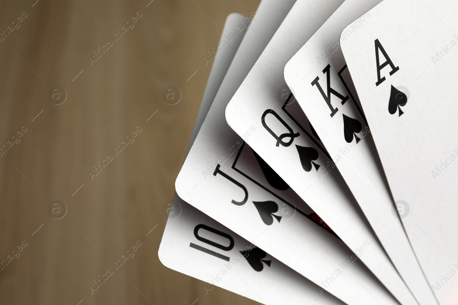 Photo of Playing cards with royal flush combination, closeup. Space for text