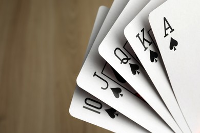 Photo of Playing cards with royal flush combination, closeup. Space for text
