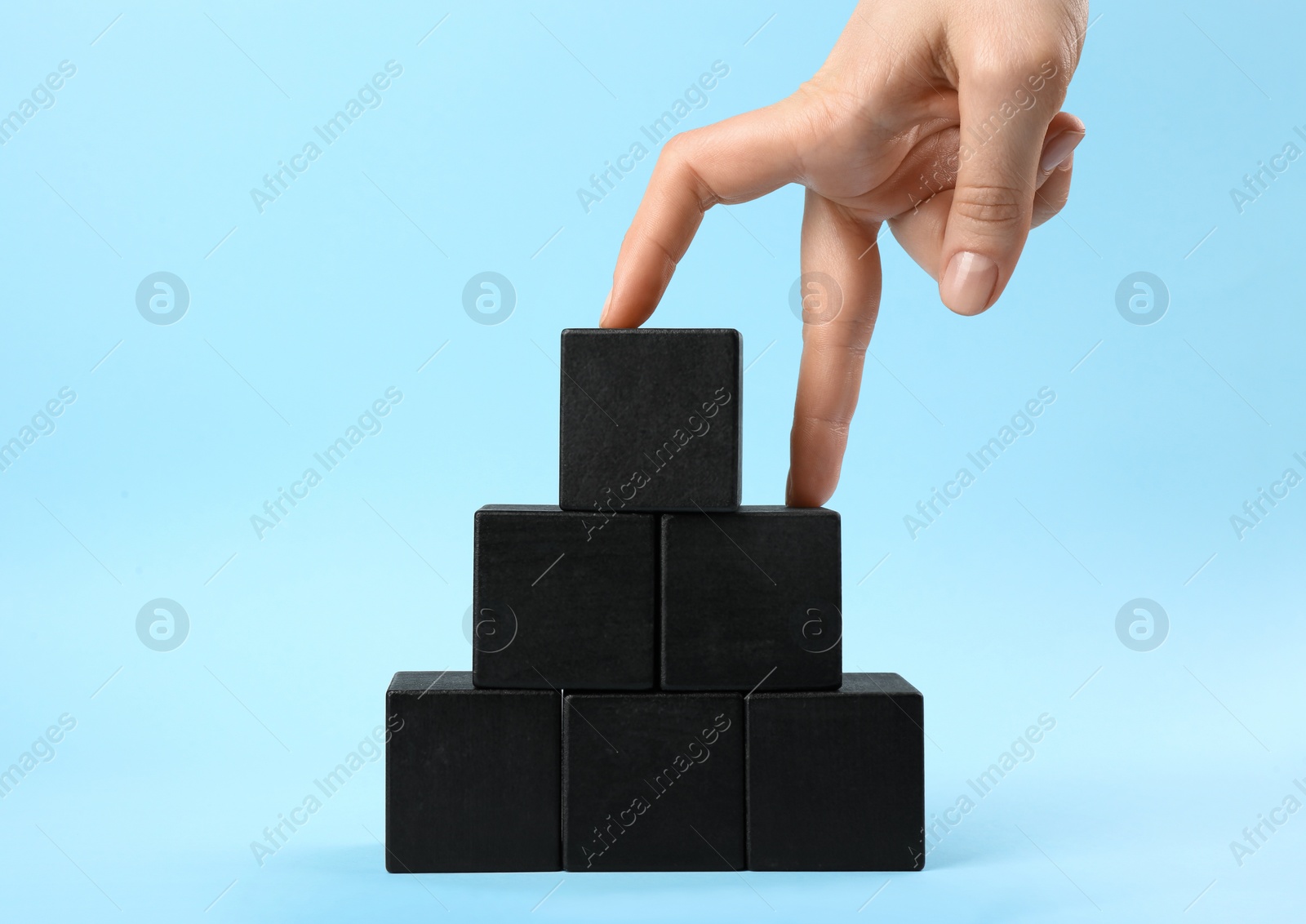 Photo of Woman imitating stepping up on wooden stairs with her fingers, closeup. Career promotion concept