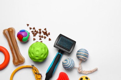 Flat lay composition with pet toys, food and accessories on white background, space for text
