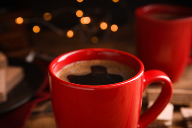 Photo of Cup of delicious black coffee on table, closeup