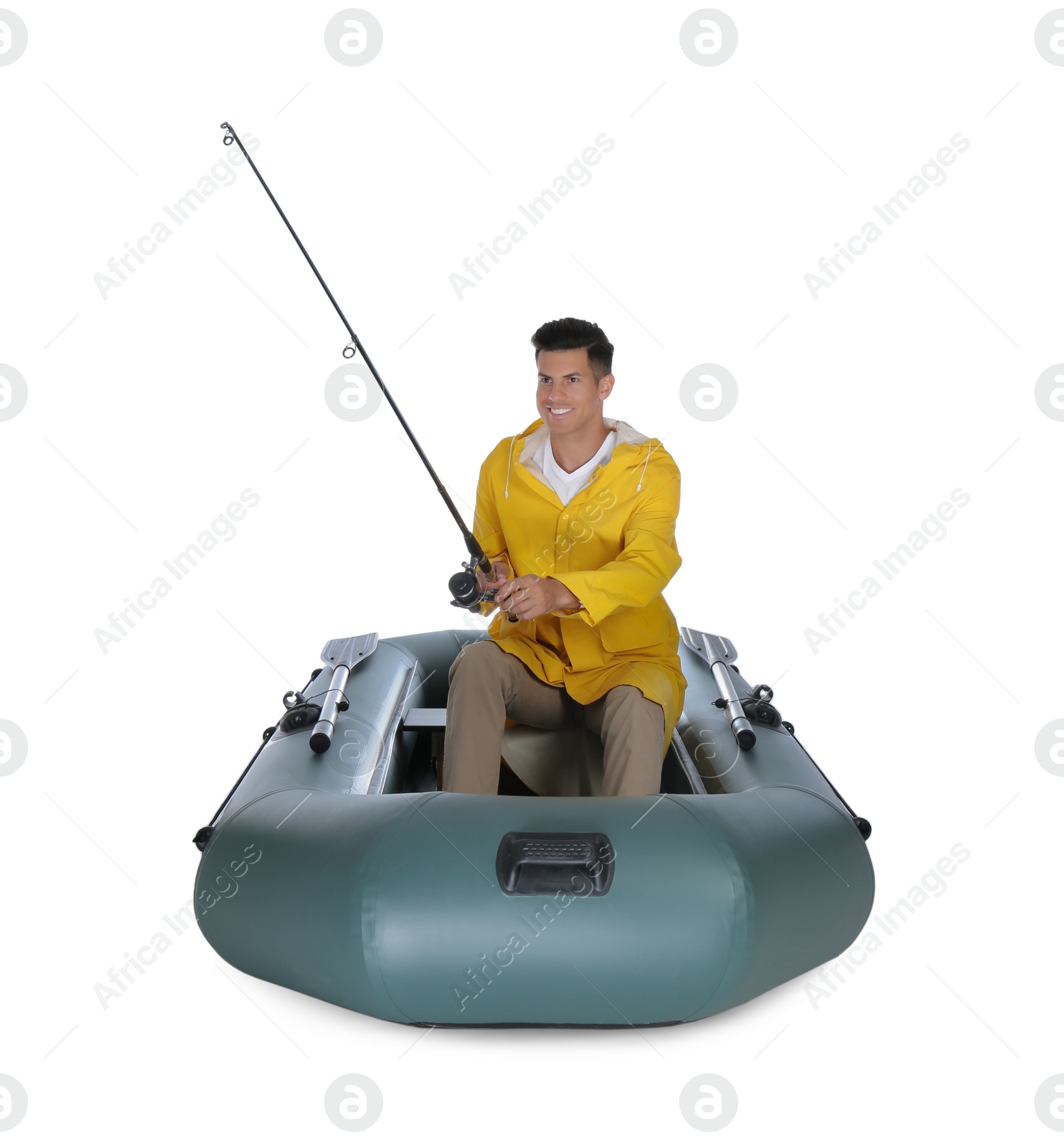 Photo of Man fishing with rod from inflatable rubber boat on white background