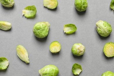 Tasty fresh Brussels sprouts on grey background, top view