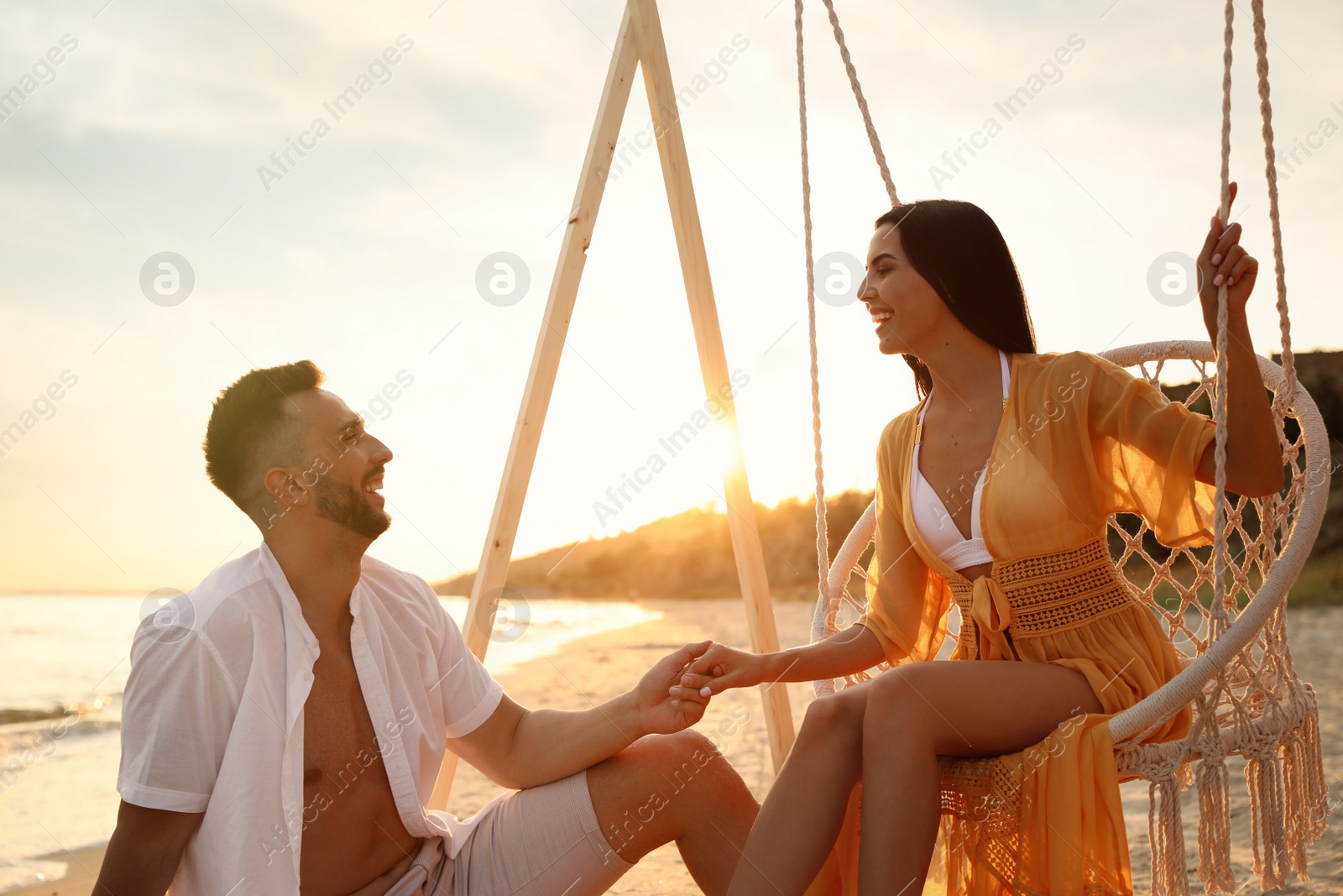 Photo of Happy young couple on beach at sunset