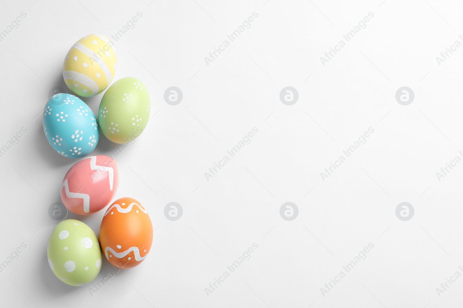 Photo of Beautiful painted Easter eggs on white background, top view