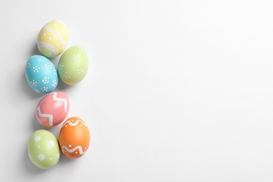 Beautiful painted Easter eggs on white background, top view