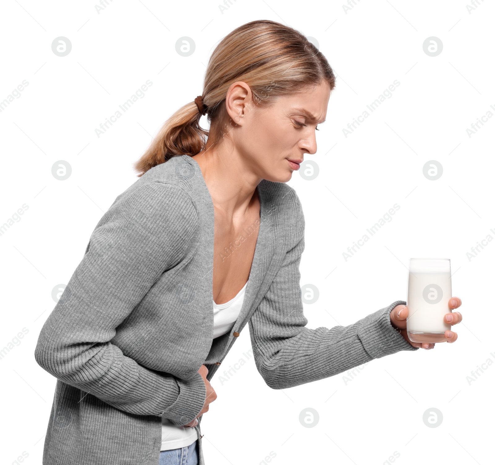 Photo of Woman with glass of milk suffering from lactose intolerance on white background