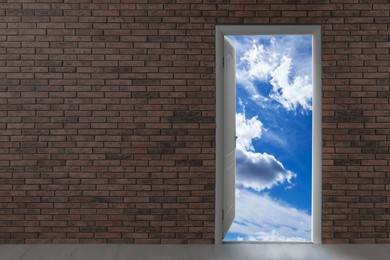 Image of Beautiful blue sky with fluffy clouds visible through open door