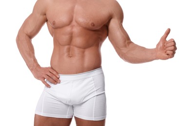 Photo of Young man is stylish underwear showing thumb up on white background, closeup
