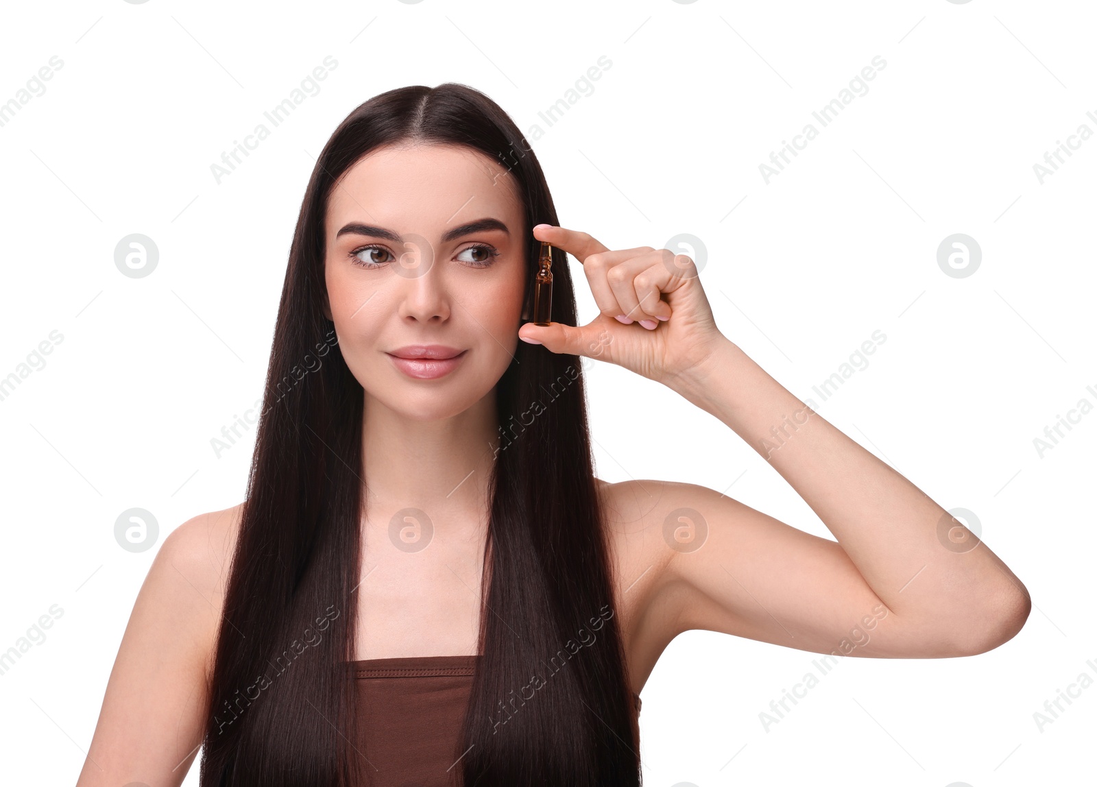 Photo of Beautiful young woman holding skincare ampoule on white background