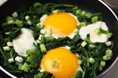 Photo of Tasty green Shakshouka in frying pan, closeup