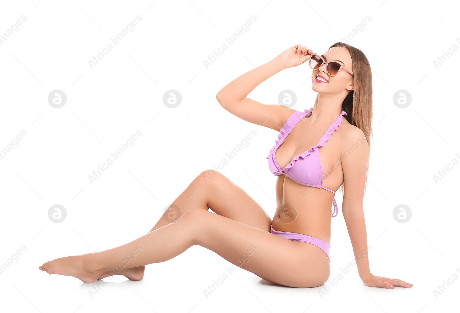 Photo of Pretty sexy woman with beautiful slim body in stylish bikini sitting on white background