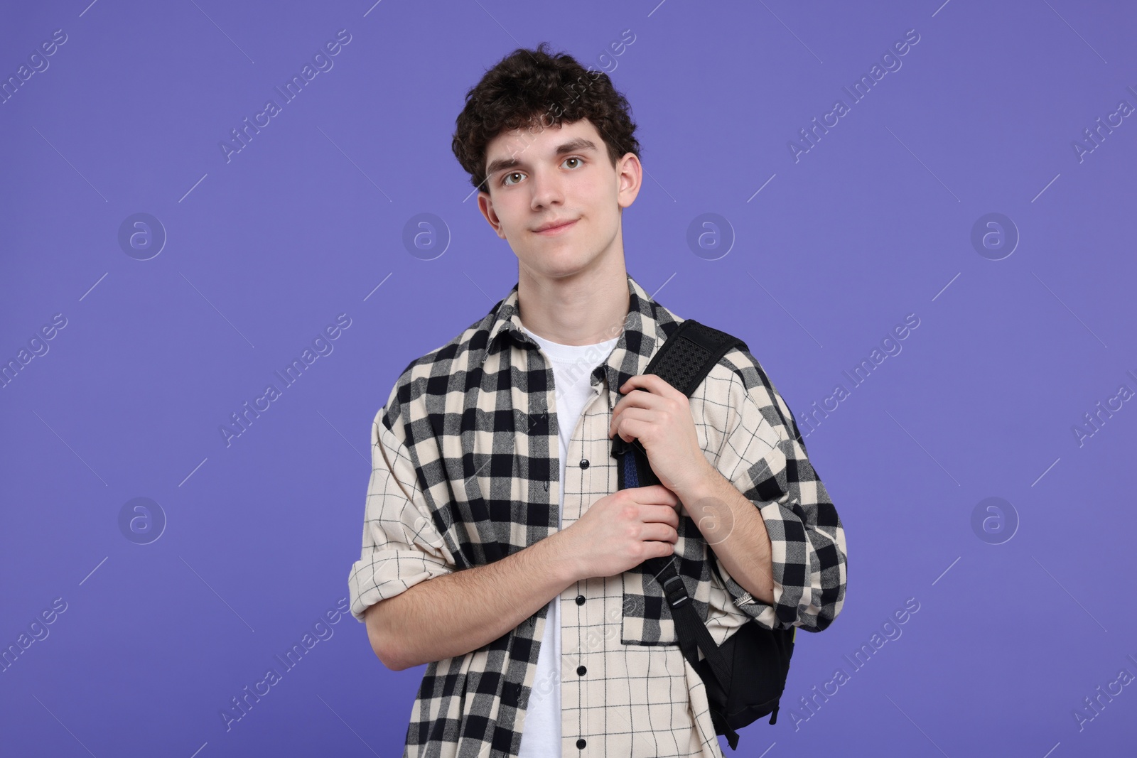 Photo of Portrait of student with backpack on purple background