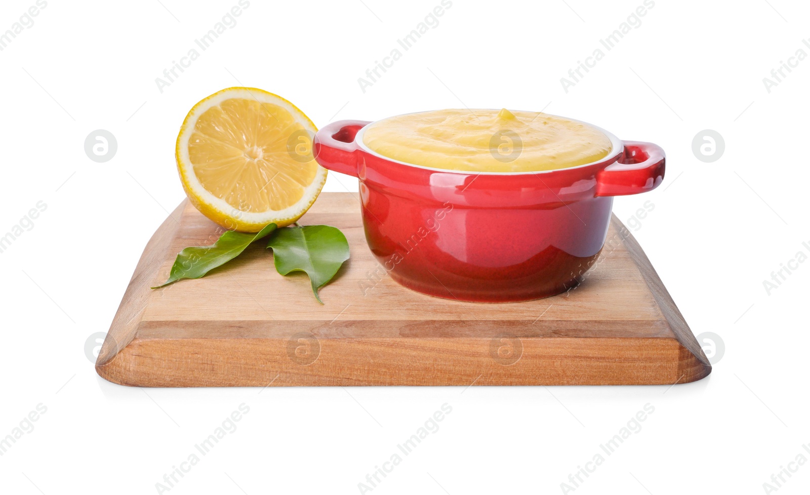 Photo of Delicious lemon curd in bowl, fresh citrus fruit and green leaves isolated on white