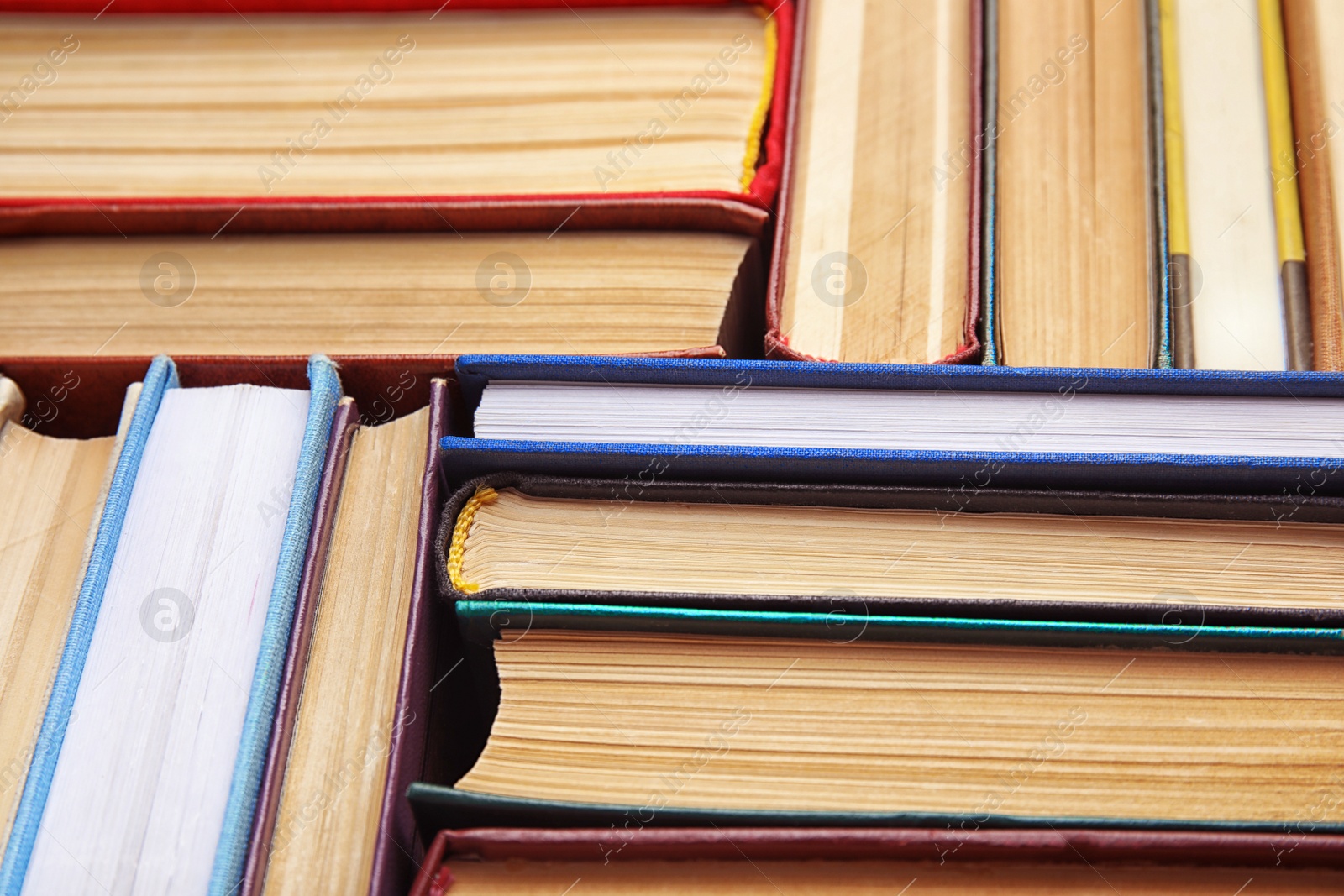 Photo of Many different hardcover books as background, closeup