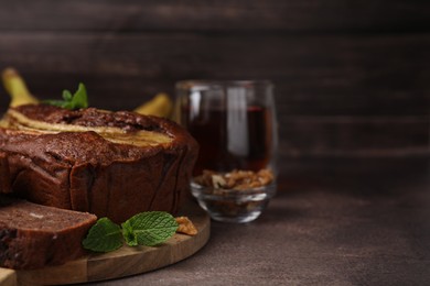 Photo of Delicious banana bread on brown table, closeup. Space for text