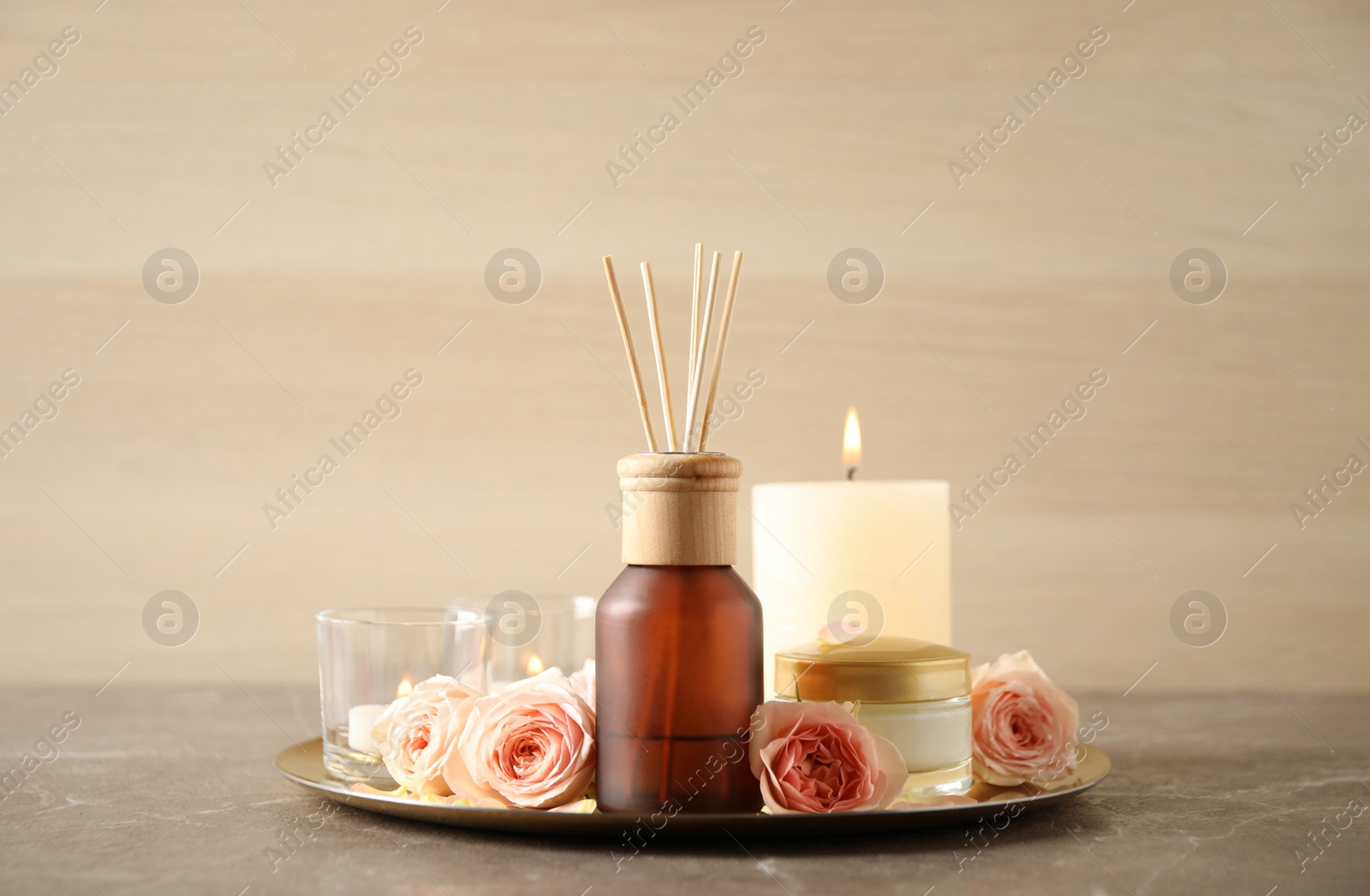 Photo of Spa composition with aroma oil and roses on grey table